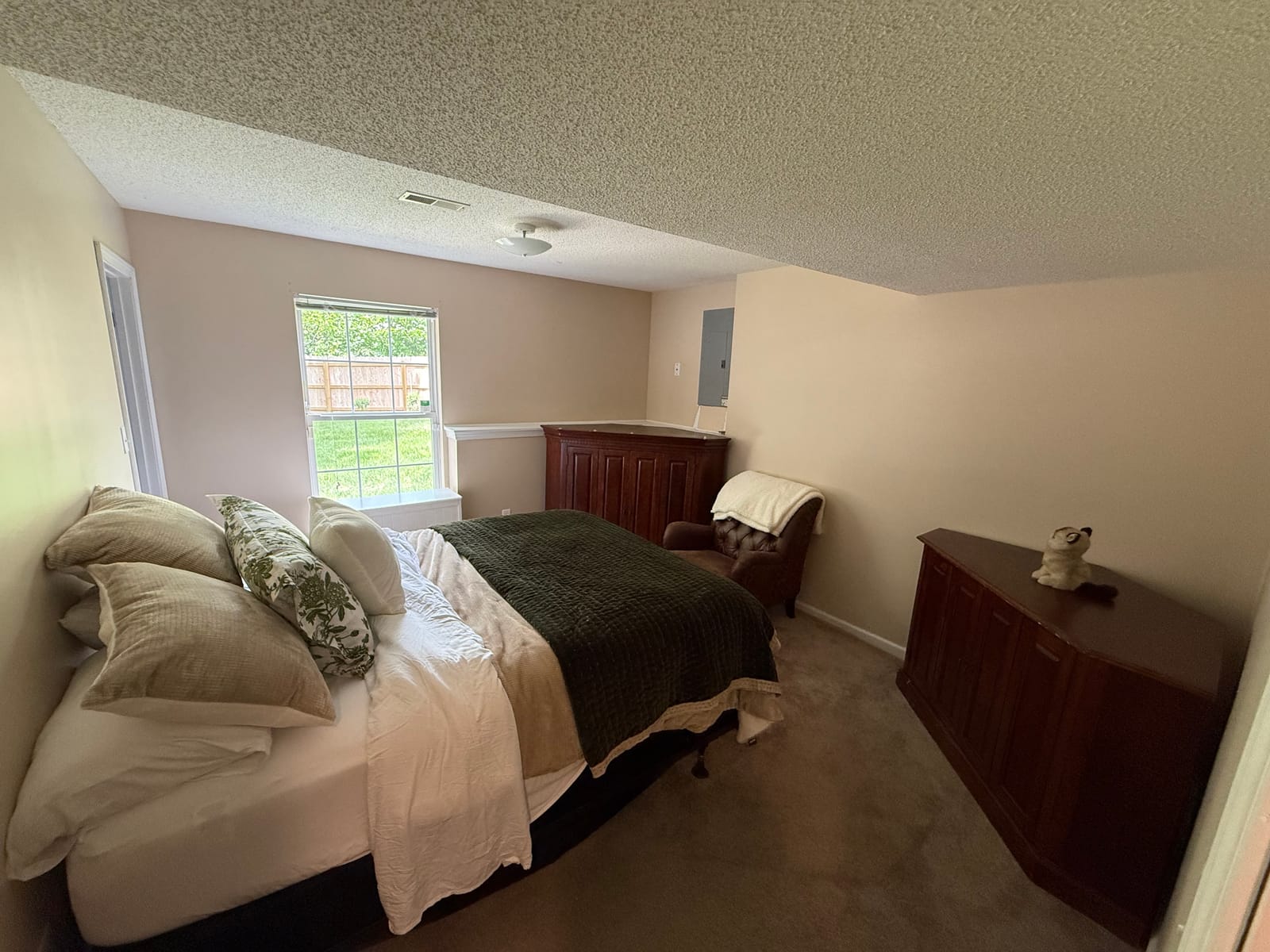 Bedroom with freshly painted neutral walls and a bright window